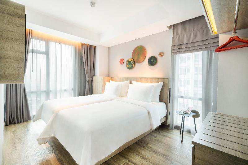 Harris Suite Puri Mansion - Oda